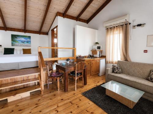 a living room with a bed and a table and a couch at אתנחתא בירדן in Mishmār Hāyardin