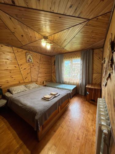 a bedroom with a bed in a log cabin at Затишний дім in Yaremche