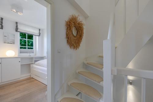 a staircase in a room with white walls at Strandliebe Sylt in Westerland