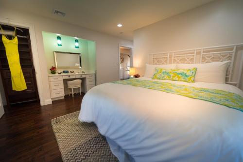 a bedroom with a large white bed and a desk at The Newport Lofts - 617 Thames Street in Newport