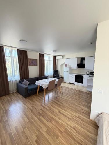 a living room with a couch and a table and chairs at Smart House Home in Kyiv