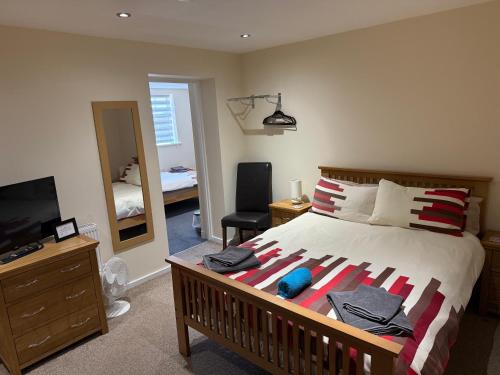 a bedroom with a large bed and a television at White Horse Tavern in Telford