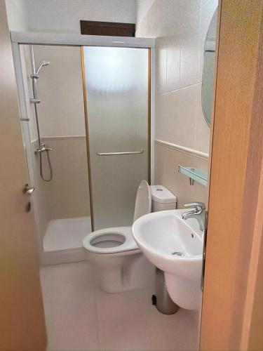a bathroom with a toilet and a sink at The Sea Breeze in Paralimni