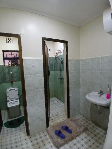 a bathroom with a shower and a sink at Friendly hostel in Arusha