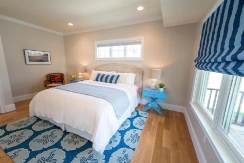 a bedroom with a bed and a blue and white rug at The Newport Lofts - 611 Thames Street in Newport