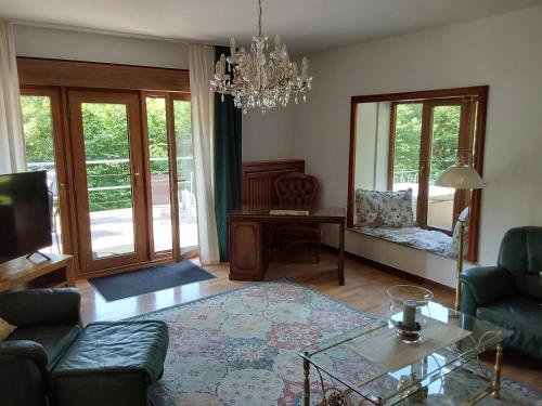 a living room with a couch and a table at Eifel Waldhaus in Simmerath
