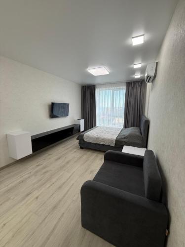 a hotel room with a bed and a couch at Квартира с Видом на Море, жк Парус, 9-3 in Chornomorsk