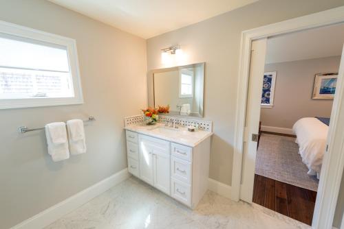 a bathroom with a sink and a mirror at The Newport Lofts - 359 Thames Street in Newport