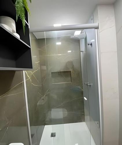 a shower with a glass door in a bathroom at Blue Sunset Prime vista do mar e varanda in João Pessoa