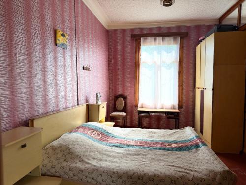 a bedroom with a bed and a window at Vefxos Guest home in Anaklia