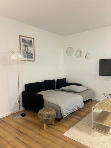 a bedroom with a bed and a tv and a table at Suite Fortuna in Mainz-Kostheim
