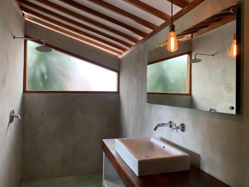 a bathroom with a sink and a mirror at Villa YAMI Uluwatu Private Infinity Pool Jungle Views in Ungasan