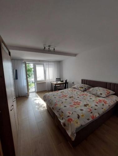 a bedroom with a bed and a table in it at Domki, pokoje, apartamenty Agata Kunowska in Ostrzyce
