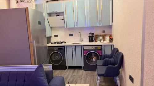 a kitchen with a washing machine and a washer at Santa Rio Taxim in Istanbul