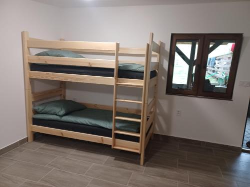 two bunk beds in a room with a mirror at Rekreačná chata TERASA in Železničná Stanica Šiatoroš