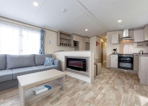 a living room with a couch and a fireplace at Unity Beach in Brean