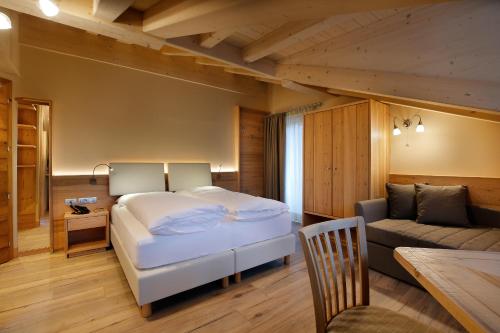Ένα ή περισσότερα κρεβάτια σε δωμάτιο στο Albergo Garnì Antico Mas del Medico