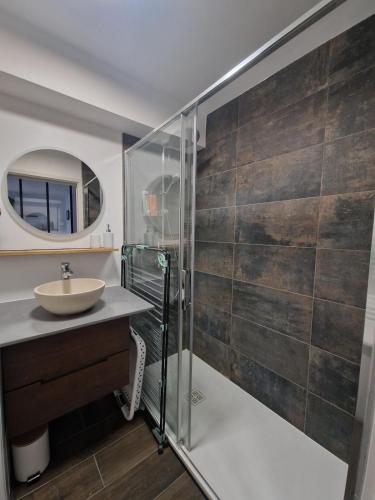 a bathroom with a sink and a glass shower at Appartement Pila - Faverges in Faverges