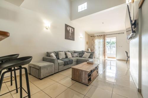 a living room with a couch and a table at Villa Mascareignas - Le Tampon in Le Tampon
