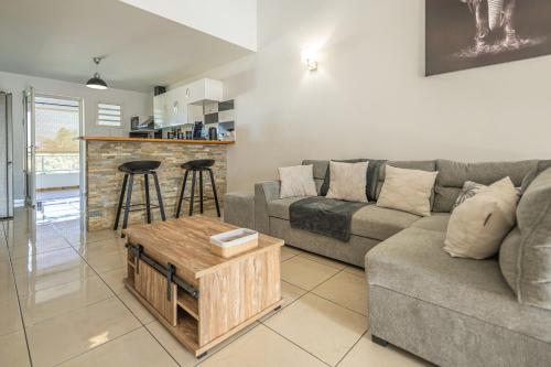 a living room with a couch and a table at Villa Mascareignas - Le Tampon in Le Tampon