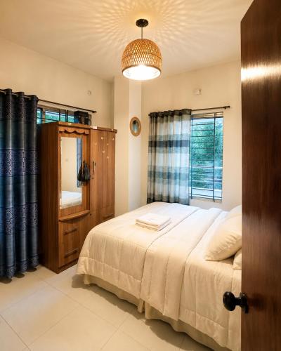 a bedroom with a large bed and a window at One Private Room Near Dhaka Airport in Dhaka