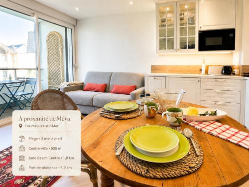a kitchen with a table with yellow plates on it at Méva in Courseulles-sur-Mer