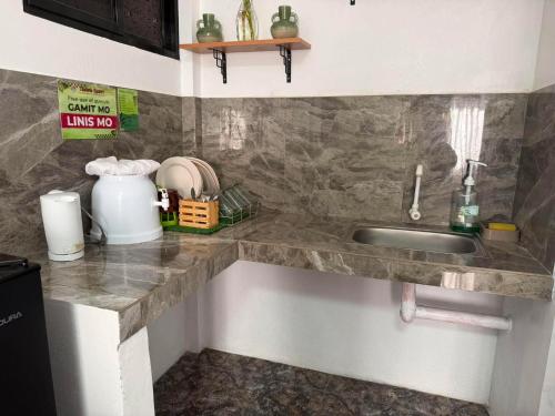 a kitchen with a sink and a counter top at Itawis Resort - Ivanna's Room in Silang