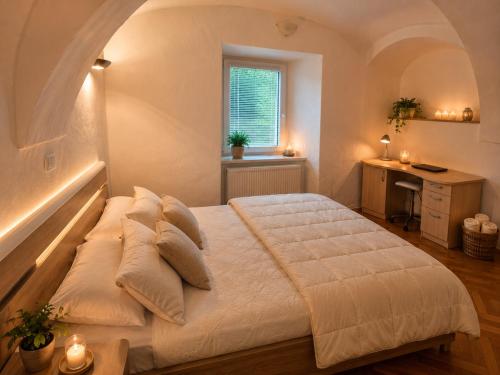 a bedroom with a bed and a desk and a window at Apartment Lagma in Železniki