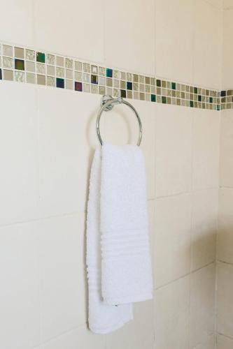 a white towel hanging on a towel rack in a bathroom at Trig Beacon in Manzini