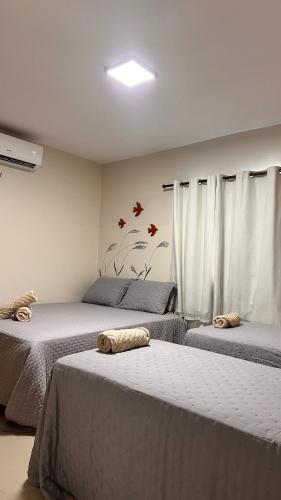 a bedroom with three beds with towels on them at Casabela - Summer Ville - Lençóis Maranhenses in Barreirinhas