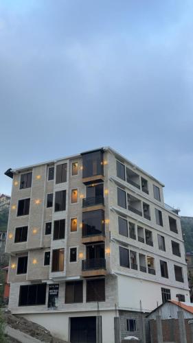 a tall apartment building with a lot of windows at Malam jabba Hotel reservation in Swat