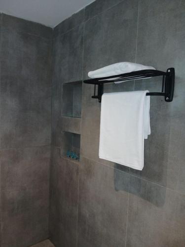 a bathroom with a shower with a white towel at wifad Hotel in Al Namas