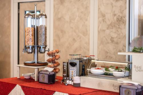 a table with a counter top with a coffee machine at Hotel Confine in Colà di Lazise