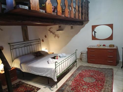 a bedroom with a bed and a dresser and a mirror at La Dimora del 1700 in Tivoli