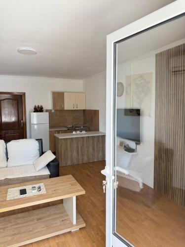 a living room with a couch and a kitchen at Apartments Ana - Airport shuttle option in Podgorica
