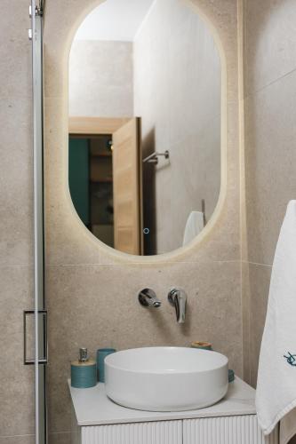 a bathroom with a sink and a mirror at Olive residence A8 in Petrovac na Moru