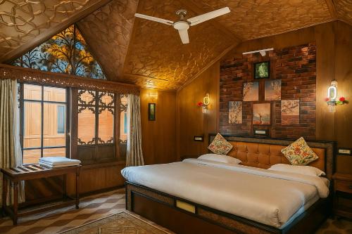 a bedroom with a large bed in a room at HAYAT Group OF Houseboats in Srinagar
