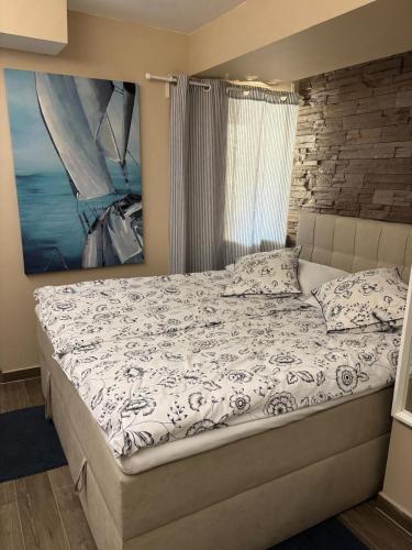 a bed in a bedroom with a painting on the wall at SALT & SOUL in Senj