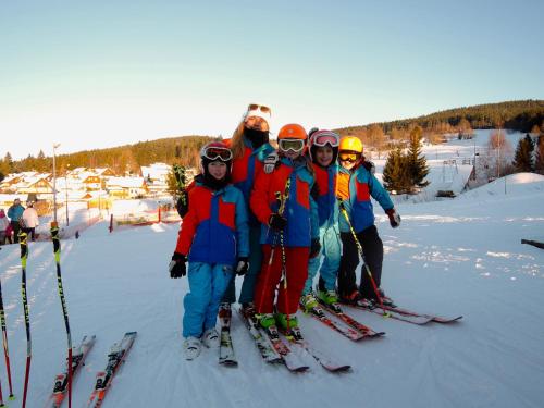 a group of people on skis in the snow at Penzion 103 in Železná Ruda