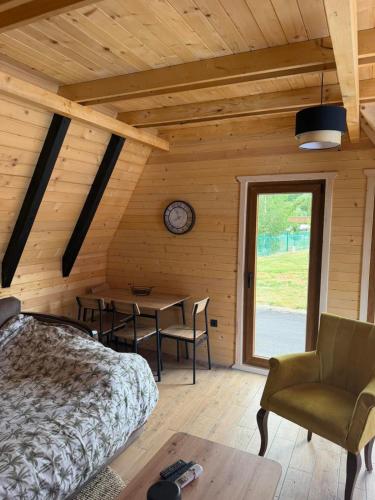 a bedroom with a bed and a table and a clock at Viaggio Berane in Berane