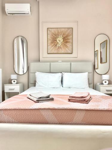 a bedroom with a bed with two towels on it at Aiginetan Apartments in Egina
