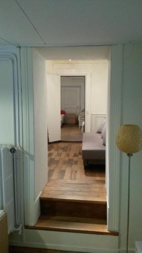 a view of a living room with a bed and a hallway at Tell Apartments Stans in Stans