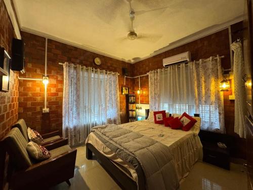 a bedroom with a bed and a couch in it at The Brick Nest in Perumpāvūr