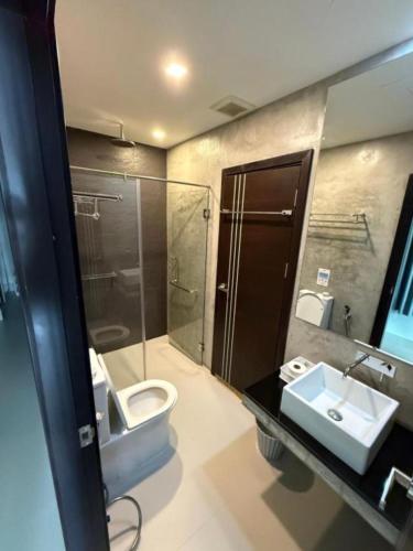 a bathroom with a toilet and a sink at Orchid Pool Villas - Koh Chang in Ko Chang