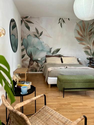 a bedroom with two beds and a table and chairs at Nella Corte - La Casetta in Corte Franca