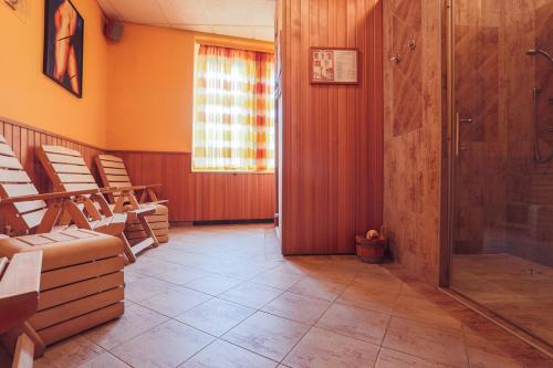 a waiting room with chairs and a shower at Hotel Victoria in Plzeň