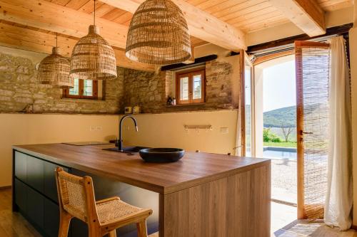 a kitchen with a large wooden island with a sink at Monte Pino in Pergola