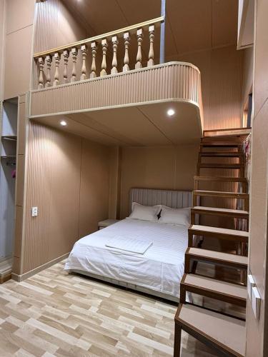 a bedroom with a bunk bed and a staircase at Red-N House in Tashkent