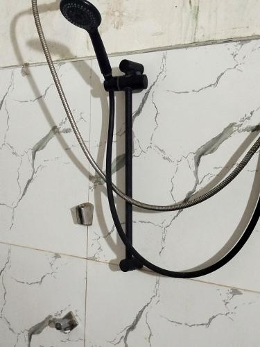 a shower head on a wall in a bathroom at Mount crest homestay in Kandy
