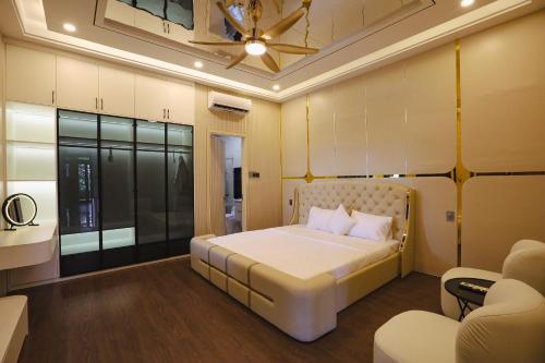 a bedroom with a large white bed in a room at Celestia Hue Villa in Hue
